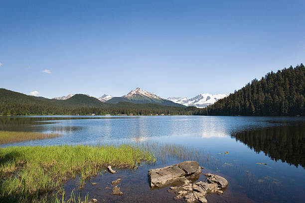 Auke Lake near Juneau, Alaska, with mountain reflections in the calm water