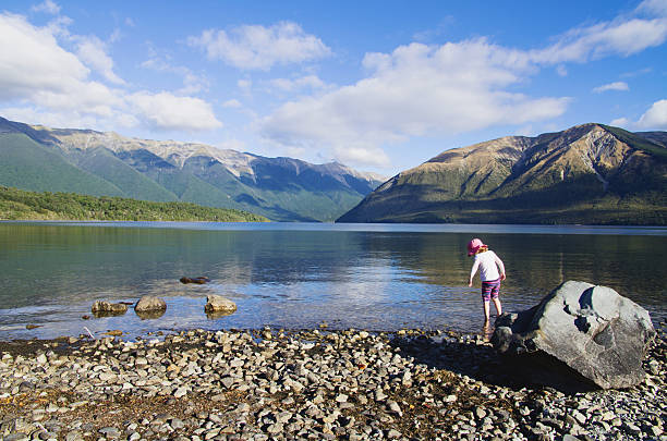 Blue waters of Kenai Lake with forested shores and mountain views
