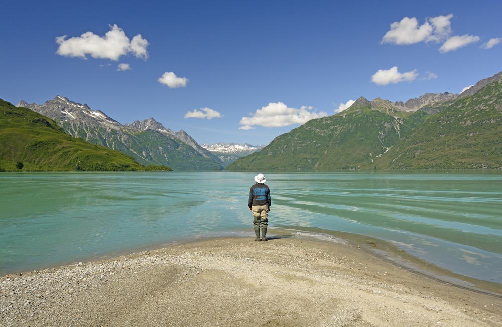 Kayaker exploring scenic Lake Clark surrounded by Alaska’s rugged landscape