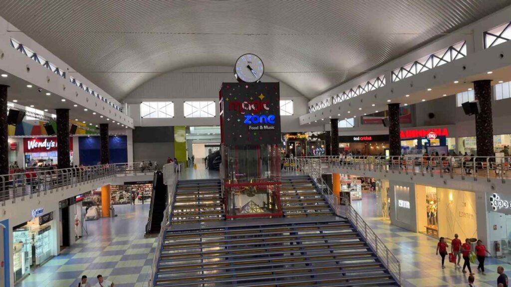 Interior view of Albrook Mall showing shops, escalators, and central atrium