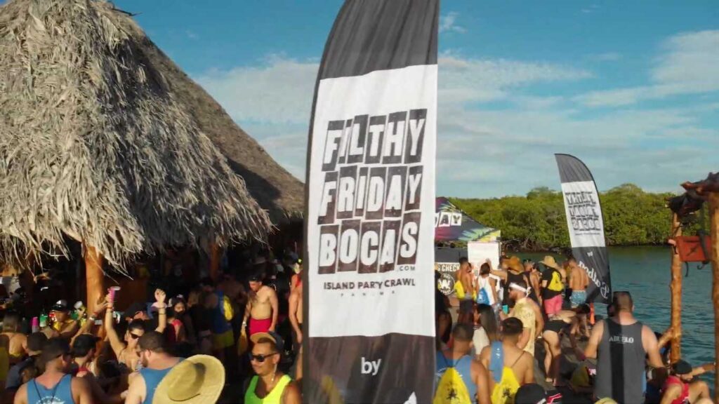 Filthy Friday Bocas island party crawl with crowds dancing and drinking at waterfront bars in Bocas del Toro, Panama.