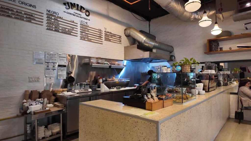 Interior of Cafe Unido in Panama showcasing a modern coffee counter and brewing station.