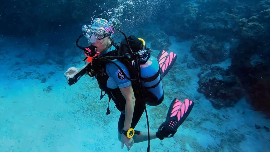 Scuba diver exploring crystal-clear waters and marine life at Coiba National Park, Panama.